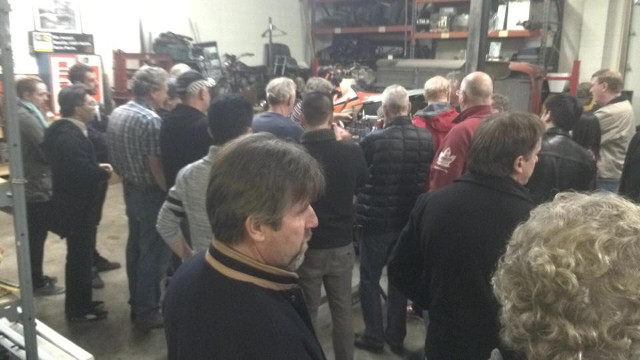 Motorsport enthusiasts attending the 2014 Formula Ford Open House watch a 20-minute transmission internals remove and install